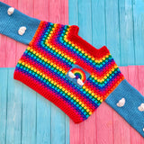 Cropped Crochet Bright Rainbow Cloud Jumper / Sweater with grey blue sleeves that have a white cloud pattern and red cuffs and a chest pocket with a rainbow and white clouds by VelvetVolcano