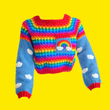 Cropped Crochet Bright Rainbow Cloud Jumper / Sweater with grey blue sleeves that have a white cloud pattern and red cuffs and a chest pocket with a rainbow and white clouds by VelvetVolcano