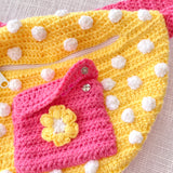 Yellow crochet bum bag with bubblegum pink strap, white polka dot print and a bubblegum pink square shaped front pocket with a yellow and white daisy by VelvetVolcano