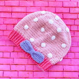 Baby Pink crochet slouchy beanie with White polka dot pattern, Bubblegum Pink contrast ribbed bottom section with a Lavender bow positioned to the side on the ribbed section. Polka Dot Bow Slouchy Beanie (Custom Colour) by VelvetVolcano