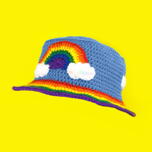 Dolphin blue crochet bucket hat with rainbow cloud motif and rainbow striped hat brim by VelvetVolcano