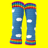 Dolphin Blue (a mid grey-blue) crochet leg warmers with white cloud appliqués and bright rainbow striped cuffs by VelvetVolcano