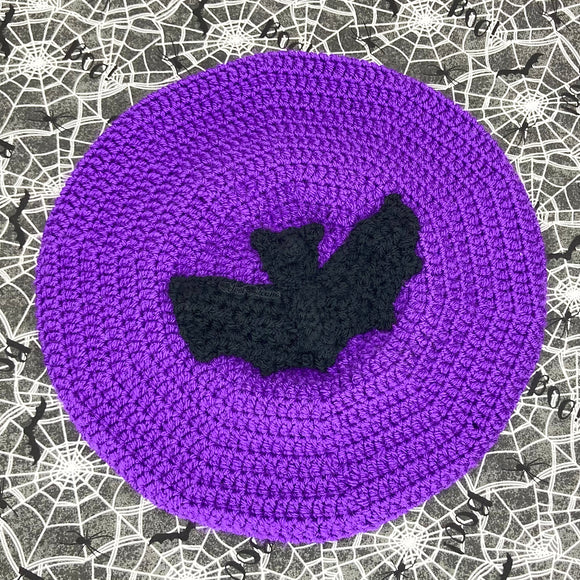 Purple crocheted beret with a black bat crocheted applique in the centre by VelvetVolcano
