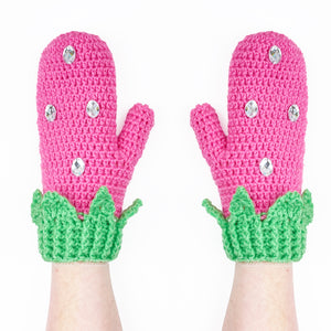 Bubblegum pink and pastel green crocheted mittens with leaf and rhinestone detail, the mittens are designed to look like strawberries. Custom Colour Kawaii Strawberry Mittens by VelvetVolcano