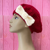 Burgundy crochet beret with a champagne white bow on the side by VelvetVolcano