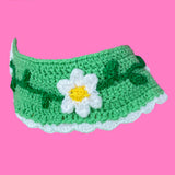 A cottagecore inspired light green crocheted Peter Pan collar with a white scalloped trim and a repeating daisy chain design on the main part of the collar by VelvetVolcano