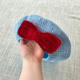 Duck Egg Blue crochet beret with a burgundy yellow bow on the side by VelvetVolcano