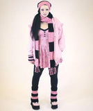 Kaya (aka Toxic Tears) wearing a Bubblegum Pink and Black outfit including VelvetVolcano Super Slouchy Polka Dot Pom Pom Beanie, Chunky Striped Scarf, Striped Flared Leg Warmers and Striped Fingerless Gloves
