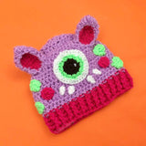 A lilac, hot pink, neon green white and black cat ear Cyclops Kitty Beanie by VelvetVolcano