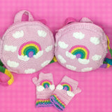 Two VelvetVolcano Pastel Rainbow Cloud Backpacks in Baby Pink with a matching pair of Pastel Rainbow Cloud Fingerless Gloves, also in Baby Pink.