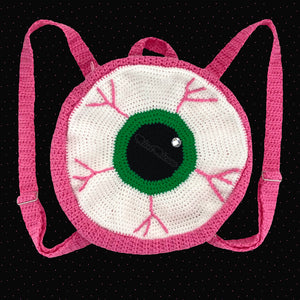 Crochet Circular Eyeball Backpack in white with an emerald green iris and bubblegum pink main part of the bag. straps and blood vessel design. Pastel Eye See You Backpack by VelvetVolcano