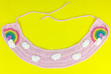 Baby Pink crochet Peter Pan style detachable collar with tie closure, repeating white cloud pattern and pastel rainbow with a cloud at the end motif of each lapel. Pastel Rainbow Cloud Collar (Baby Pink) by VelvetVolcano