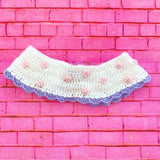 White crochet Peter Pan collar with baby pink polka dot pattern, lavender scallop trim and lilac bows on the lapels of the collar. The collar fastens with a braided tie. Polka Dot Bow Collar by VelvetVolcano