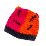 Half orange, half hot pink crochet beanie with cat ears and a black ribbed brim, designed to look like a Frankenstein's Monster Kitty. Custom Colour FrankenKitty Beanie by VelvetVolcano