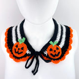 Black and white striped crochet Peter Pan style collar with orange scallop trim around the bottom edge and halloween inspired jack o' lantern appliques on the lapels of the collar. Pumpkin Stripe Collar by VelvetVolcano