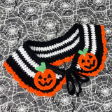 Black and white striped crochet Peter Pan style collar with orange scallop trim around the bottom edge and halloween inspired jack o' lantern appliques on the lapels of the collar. Pumpkin Stripe Collar by VelvetVolcano