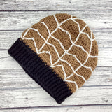 Light fudge brown crochet slouchy beanie with white spider web design and black ribbed brim by VelvetVolcano