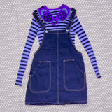 VelvetVolcano Witchy Collar in Violet, Grey and Black with a lilac and black striped top and a dark denim pinafore dress.