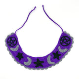 VelvetVolcano Witchy Collar, a violet Peter Pan style crochet detachable collar with black pentagrams, grey moons and black stars and a grey scallop trim around the bottom edge.