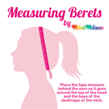 Measuring Berets graphic by VelvetVolcano that shows a pink outline of a person with a ponytail and a darker pink tape measure wrapped around their head. There is text that says “Place the tape measure behind the ears so it goes around the top of the head and the base of the skull/nape of the neck.”