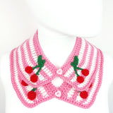 Bubblegum pink and white striped Peter Pan style detachable crochet collar with red and green cherry appliques on the lapels of the collar and a pink heart shaped button fastening. Cherry Stripe Collar by VelvetVolcano