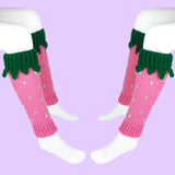 Bubblegum pink crochet leg warmers designed to look like strawberries with emerald green top cuffs that feature little green leaves and silver rhinestone seeds by VelvetVolcano