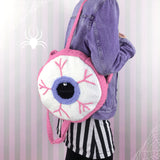 Crochet Circular Eyeball Backpack in white with a Lavender iris and bubblegum pink main part of the bag. straps and blood vessel design. Pastel Eye See You Backpack by VelvetVolcano