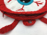 Zip opening, hanging hook and straps detail on Crochet Eyeball Backpack by VelvetVolcano