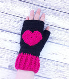 Black crochet hand warmers with hot pink heart design and hot pink cuffs. Heart Fingerless Gloves by VelvetVolcano