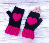 Black crochet hand warmers with hot pink heart design and hot pink cuffs. Heart Fingerless Gloves by VelvetVolcano