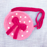 Bubblegum pink circular shaped crochet shoulder bag with white polka dot pattern, hot pink strap and hot pink bow with tails in the centre of the bag. Polka Dot Bow Bag (Custom Colour) by VelvetVolcano