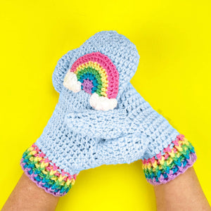 Light blue crochet mittens with pastel rainbow and cloud design and pastel rainbow striped cuffs by VelvetVolcano