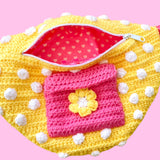 Yellow crochet bum bag with bubblegum pink strap, white polka dot print and a bubblegum pink square shaped front pocket with a yellow and white daisy by VelvetVolcano