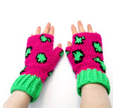 Hot pink crochet hand warmers with black and fluorescent green leopard print design and neon green cuffs. Leopard Fingerless Gloves (Custom Colour) by VelvetVolcano