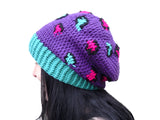 Purple crochet hat with pink, teal and black leopard print detail. Slouchy Leopard Beanie (Custom Colour) by VelvetVolcano