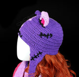 Half lilac, half violet Frankenstein's Monster inspired crochet cat ear, ear flap beanie with cerise pink inner ears and pom poms. Custom Colour FrankenKitty Ear Flap Beanie by VelvetVolcano