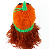 Halloween inspired orange crochet hat with contrasting neon green ribbed bottom section, neon green stem and a black carved jack o' lantern face on the main part of the hat. Pumpkin Beanie by VelvetVolcano