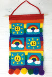 Sunshine & Rainbows Hanging Organiser - Colourful Rainbow Striped Crochet Wall Art with Sun and Rainbow Cloud Pockets and Pom Pom Trim by VelvetVolcano