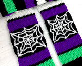 Purple, neon green, black and white striped crochet scarf with white cobweb panels and multicoloured tassels. Spider Web Stripe Scarf (Custom Colour) by VelvetVolcano