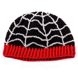 Black fitted crochet beanie with light grey spider web / cobweb design and red ribbed brim by VelvetVolcano